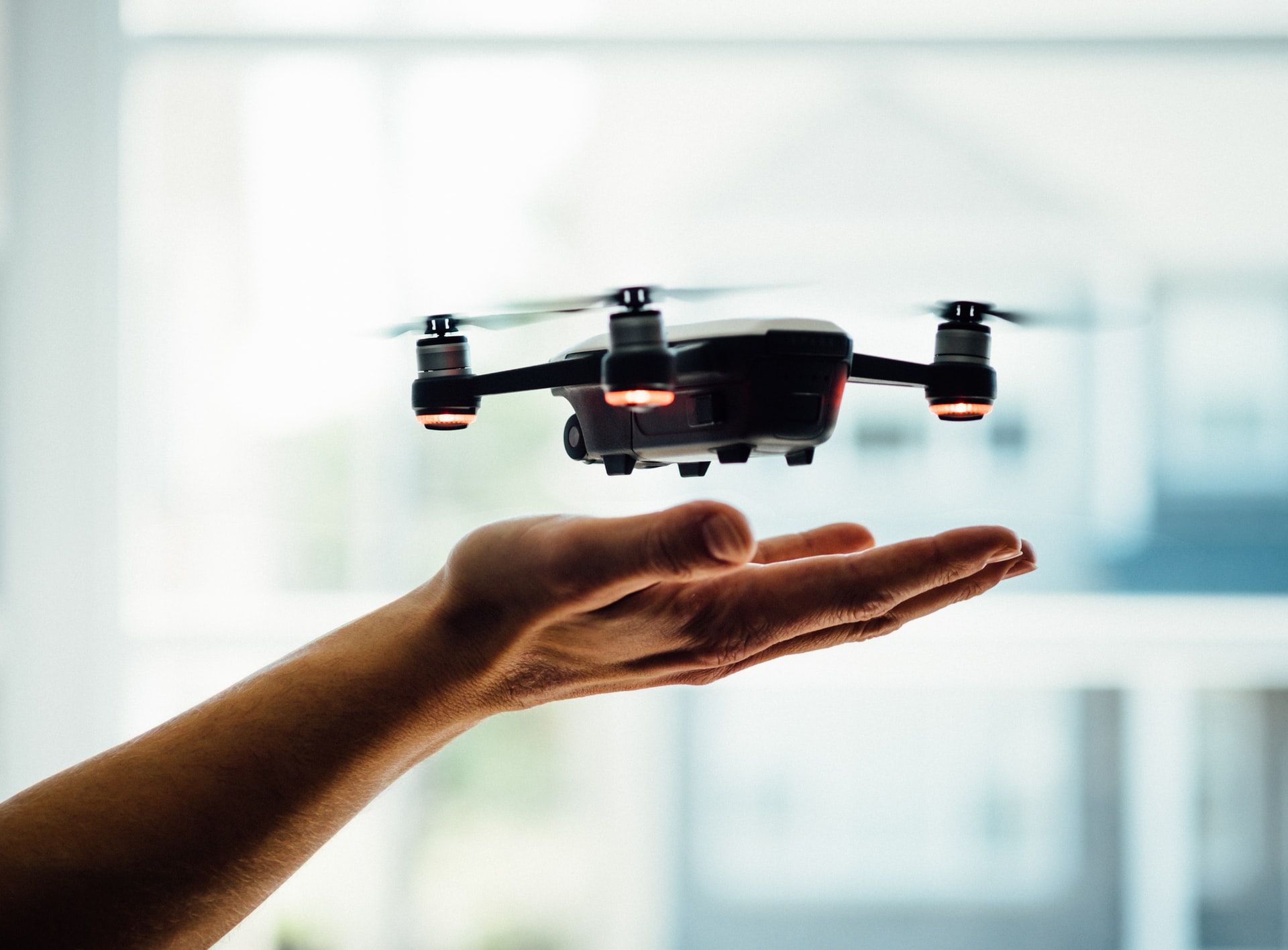 Photo of drone floating over hand